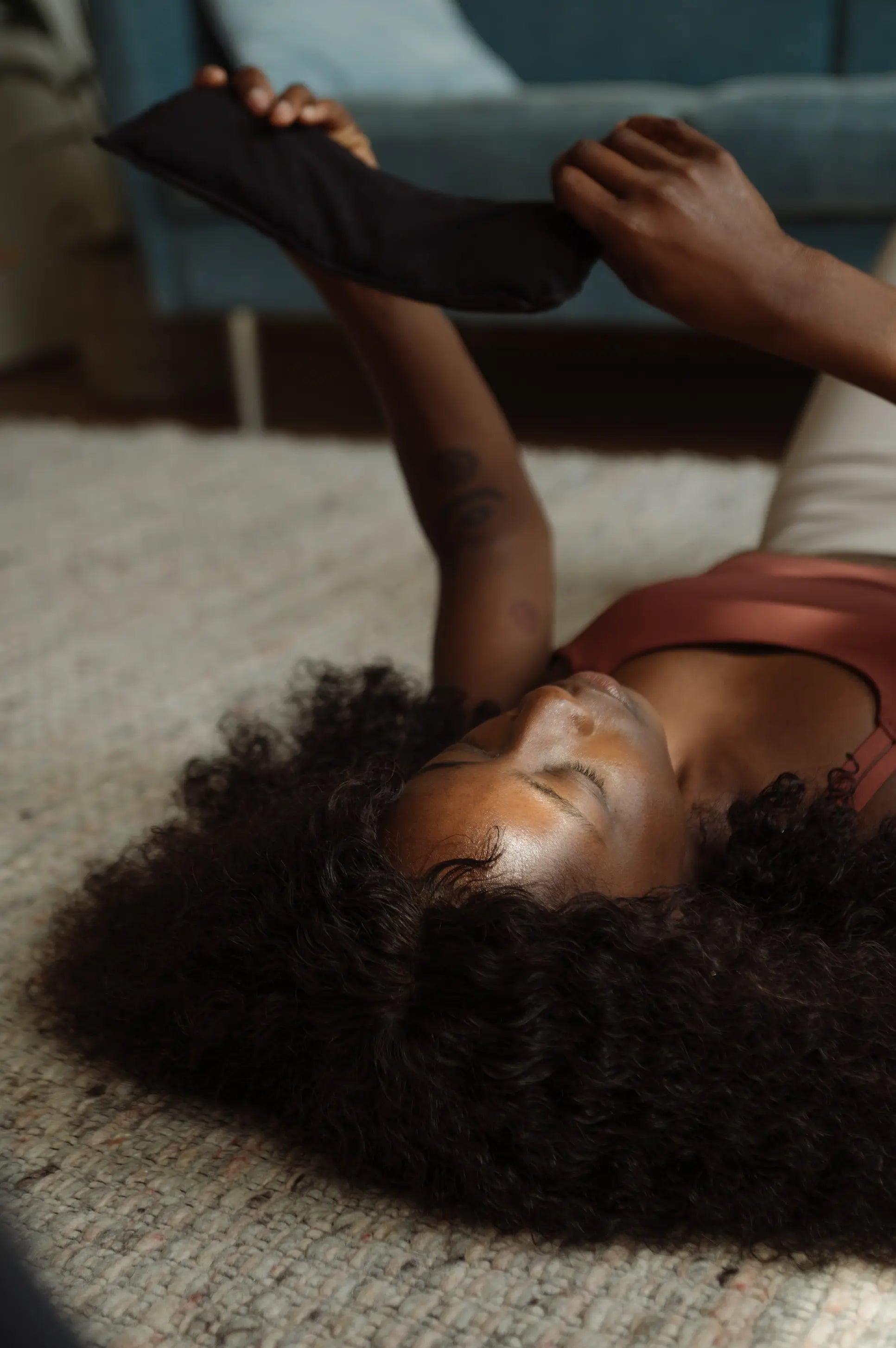 A woman uses the Shakti Eye Pillow. 