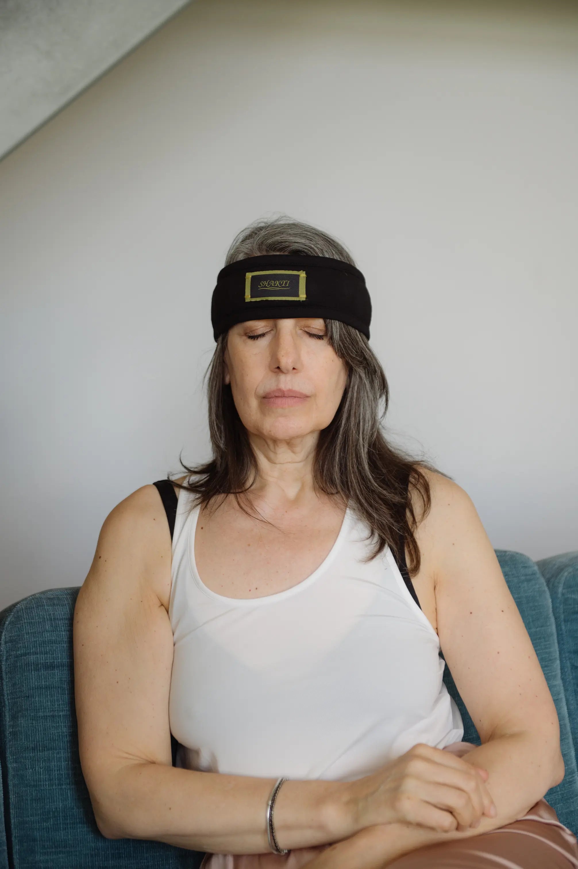 A woman relaxes with the Shakti headband.