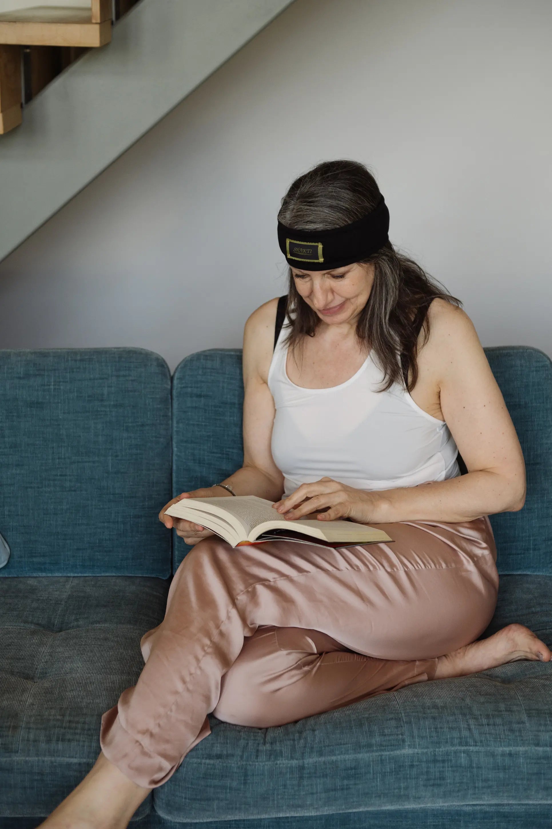 The Shakti headband is used when relaxing with a book.