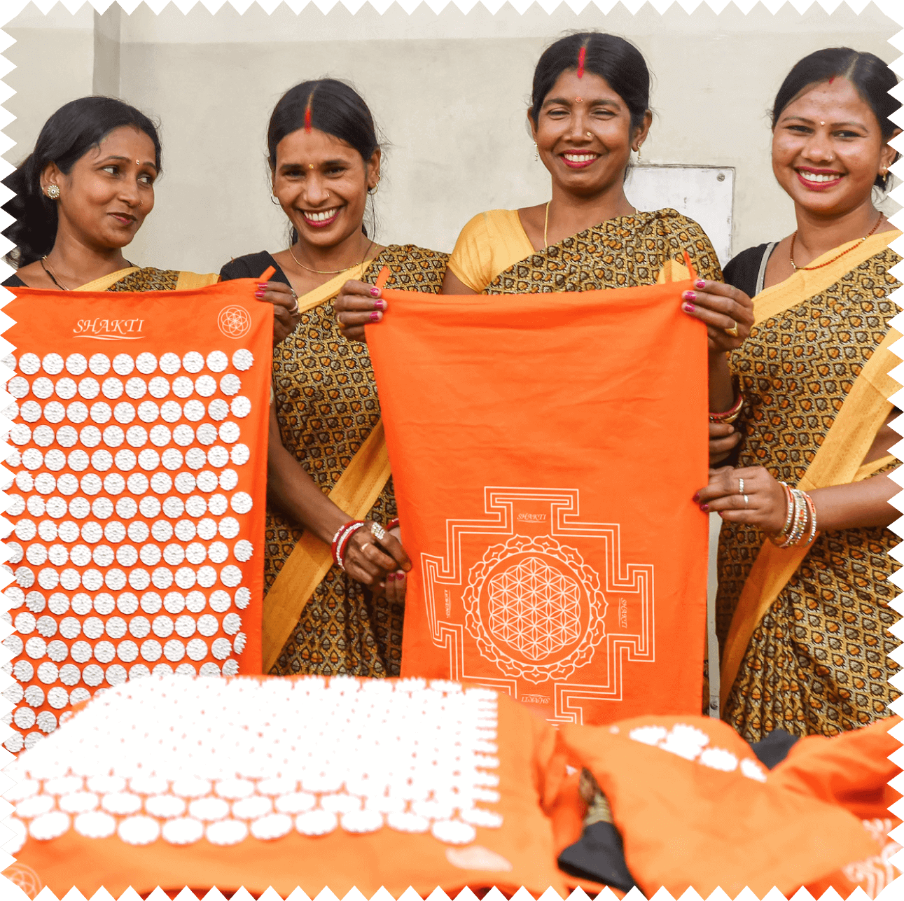 The team in Delhi proudly shows off their handmade Shakti acupressure mats.